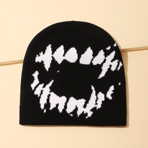 Detailed texture of black knit beanie featuring a bold white fangs mouth pattern print