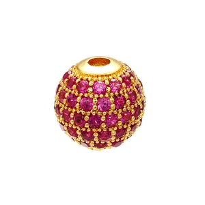 Close-up of gold-plated micro-pave round bead with vibrant red crystal settings