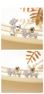 Detailed macro view of bone-shaped stud earring with bow and floral zircon inlay
