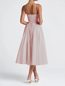 Detail of elegant pink midi dress with adjustable lace-up tie back and flowing skirt
