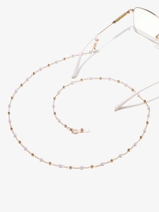 Detail of gold metal chain with light purple pearls and non-slip rubber loops for glasses