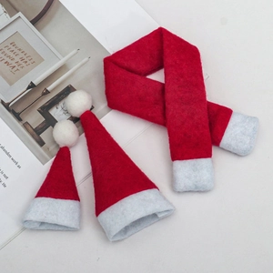 Close-up of three-piece mini Christmas knit set with red scarfs and felt hats for decor