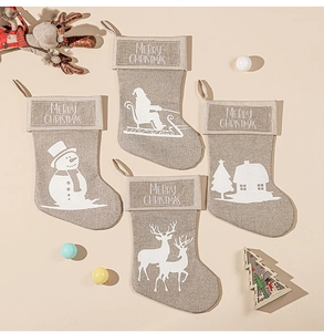 Set of 4 linen Christmas stockings featuring white Santa, snowman, and reindeer prints