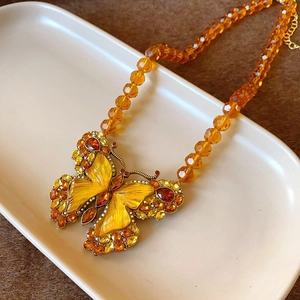 Vintage gold-toned butterfly necklace set with yellow crystals and amber beaded chain