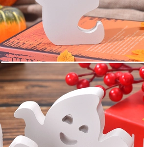 Close-up of white wooden ghost decor featuring cute facial details and sturdy base