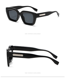 Detail of square black sunglasses with silver metal rectangular accents on the temples