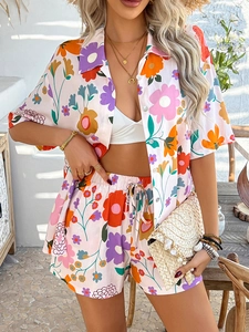 Detail of bohemian floral print two-piece set featuring button-up shirt and drawstring shorts