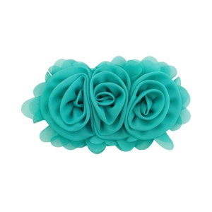 Close-up of handmade turquoise chiffon rose flower hair clip with delicate leaf details