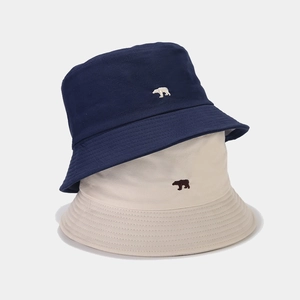 Minimalist cotton bucket hats with polar bear embroidery in navy blue and cream white