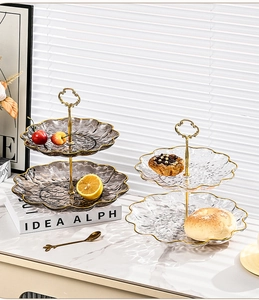 Close-up of dual-tier glass fruit platters with gold trim and textured hammered finish
