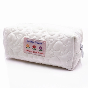 White heart-quilted fabric cosmetic bag with Lucky Flower label and zip closure