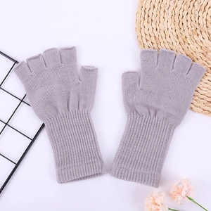 Detailed texture of grey knit arm warmers with ribbed cuffs and soft acrylic material