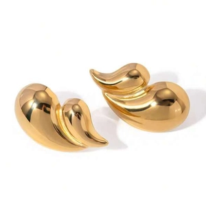 Macro detail of glossy gold-plated chunky double-layer teardrop earrings with mirror finish
