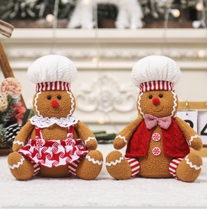 Detailed view of plush gingerbread man couple dolls with knit hats and festive decorations