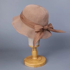 Detail of the high-density knit texture and large bow on this brown fisherman hat