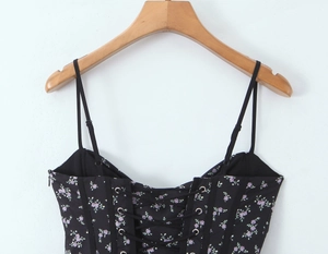 Detailed view of floral corset top featuring adjustable lace-up front and thin straps