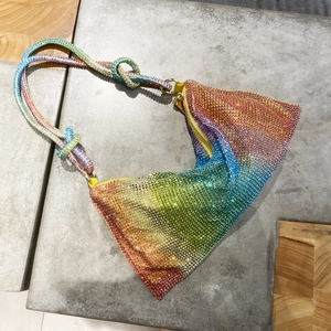 Detail of triangle rhinestone handbag with rainbow gradient crystals and knotted strap