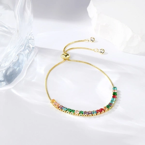 Detail of adjustable gold bracelet featuring vibrant rectangular rainbow zircons