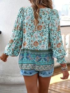 Back view of bohemian long-sleeve blouse featuring floral paisley print and puff sleeves