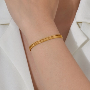 Three-layer gold stainless steel snake and bead chain bracelet worn on wrist
