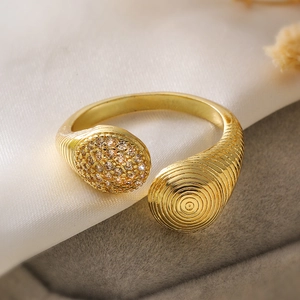 Detailed macro view of gold geometric ring with pave zircon and spiral texture detail