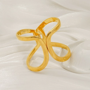 Minimalist gold hollow geometric hair claw clip on white silk and ceramic plate background