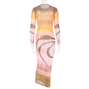 Close-up of abstract sunset gradient print on a sheer mesh long-sleeved dress