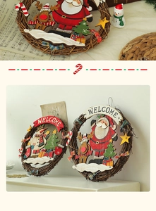 Detail of Christmas welcome door wreath featuring Santa and Snowman wood carvings