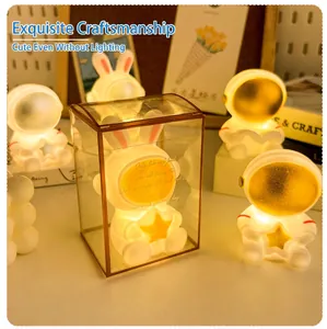 Astronaut night light with rabbit ears and glowing star in a transparent acrylic gift box