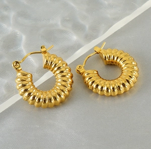 Detailed view of 18K gold plated stainless steel croissant hoop earrings with ribbed texture
