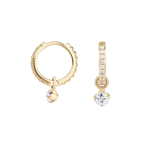 Close-up of gold hoop earrings with pavé crystals and round hanging gemstone charms