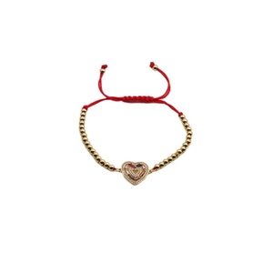 Detail showing red woven rope bracelet with gold beads and heart-shaped colorful zircon