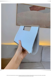 Detail of light blue sequin evening clutch bag with elegant silver metallic handle frame