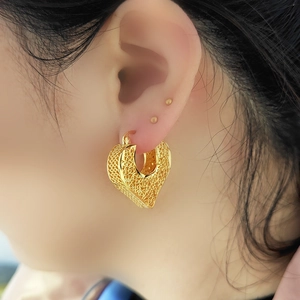 Vintage gold hollow heart earrings for women with detailed floral relief engraving