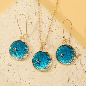Detailed close-up of blue enamel starfish necklace and earrings on a textured stone