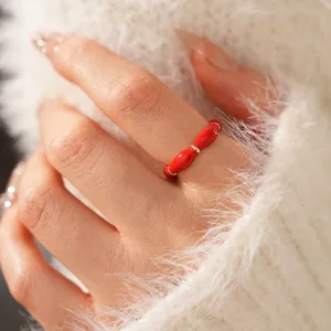 Luxury gold plated red enamel oval open ring for women on soft white fabric