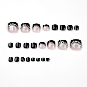 Elegant black and pink press-on toenails with white floral art and rhinestones