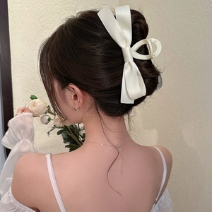 French style white satin bow hair claw clip worn on model's head for an elegant updo
