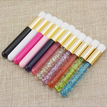Detail of colorful disposable makeup brushes with glitter handles and gold aluminum tubes