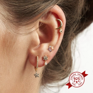 Detailed close-up of s925 silver stud earrings with colorful zircon and star charms