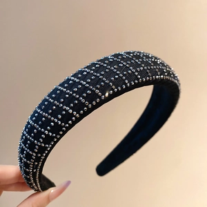 Macro shot of black fabric headband with silver rhinestones in a geometric grid pattern