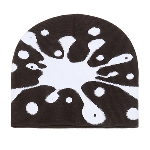 Detail of knit beanie with black and white abstract splatter pattern and fine texture