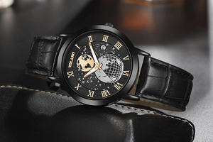 Detail of men's watch with moon phase dial, rose gold hands and black leather strap