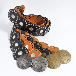 Detail of western vintage waist belt with hollow hexagons and large hammered metal discs