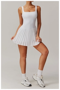 Detailed full body view of a white pleated tennis dress with wide straps and square neck