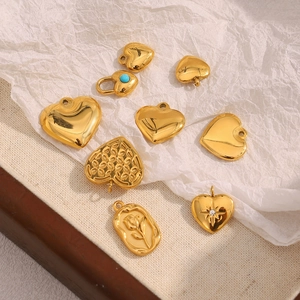Detailed close-up of 18K gold-plated heart charms with turquoise and floral patterns