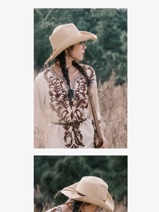 Detailed embroidery on bohemian dress paired with a woven beige straw cowboy sun hat