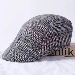 Close-up of classic black and white houndstooth flat cap with thick wool texture