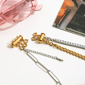 Detail of 18k gold and silver magnetic layered necklace clasps on multiple chains