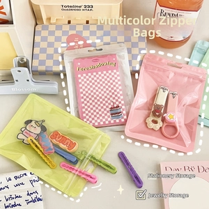 Macro detail of multi-colored translucent resealable bags for stationery and jewelry storage